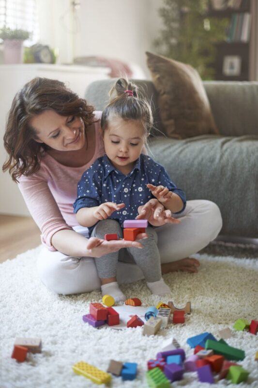 Mother kid playing with toys